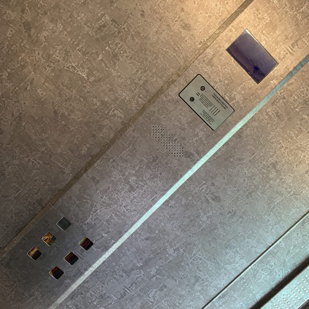 A view of the floor from above shows a light switch and electrical box.