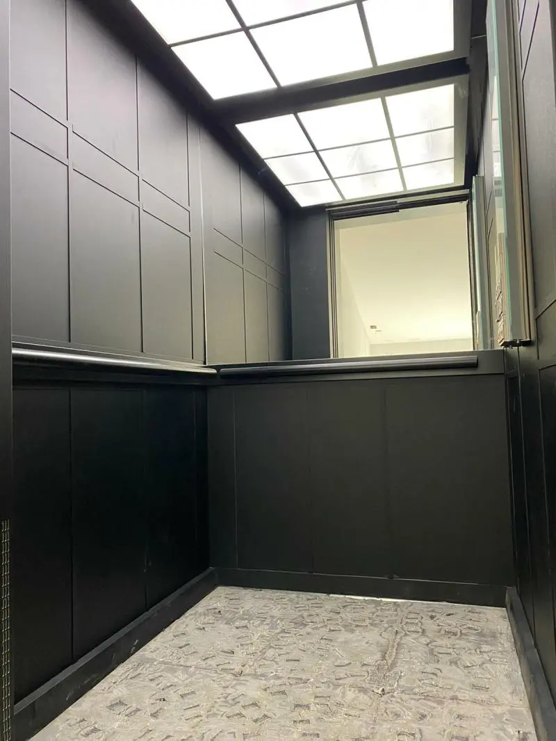 A room with black cabinets and a light on the ceiling.