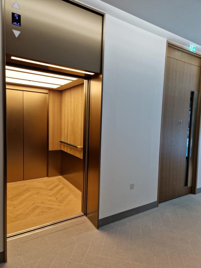 A room with two lifts and a door.