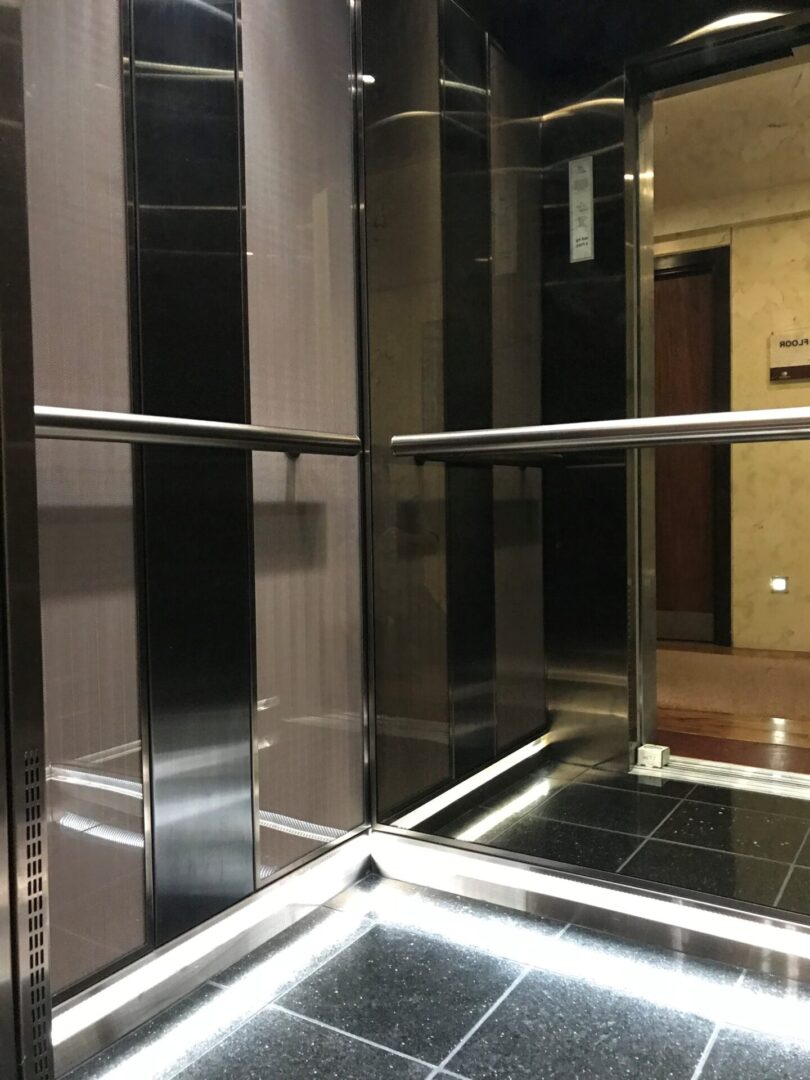 A mirror image of the inside of an elevator.