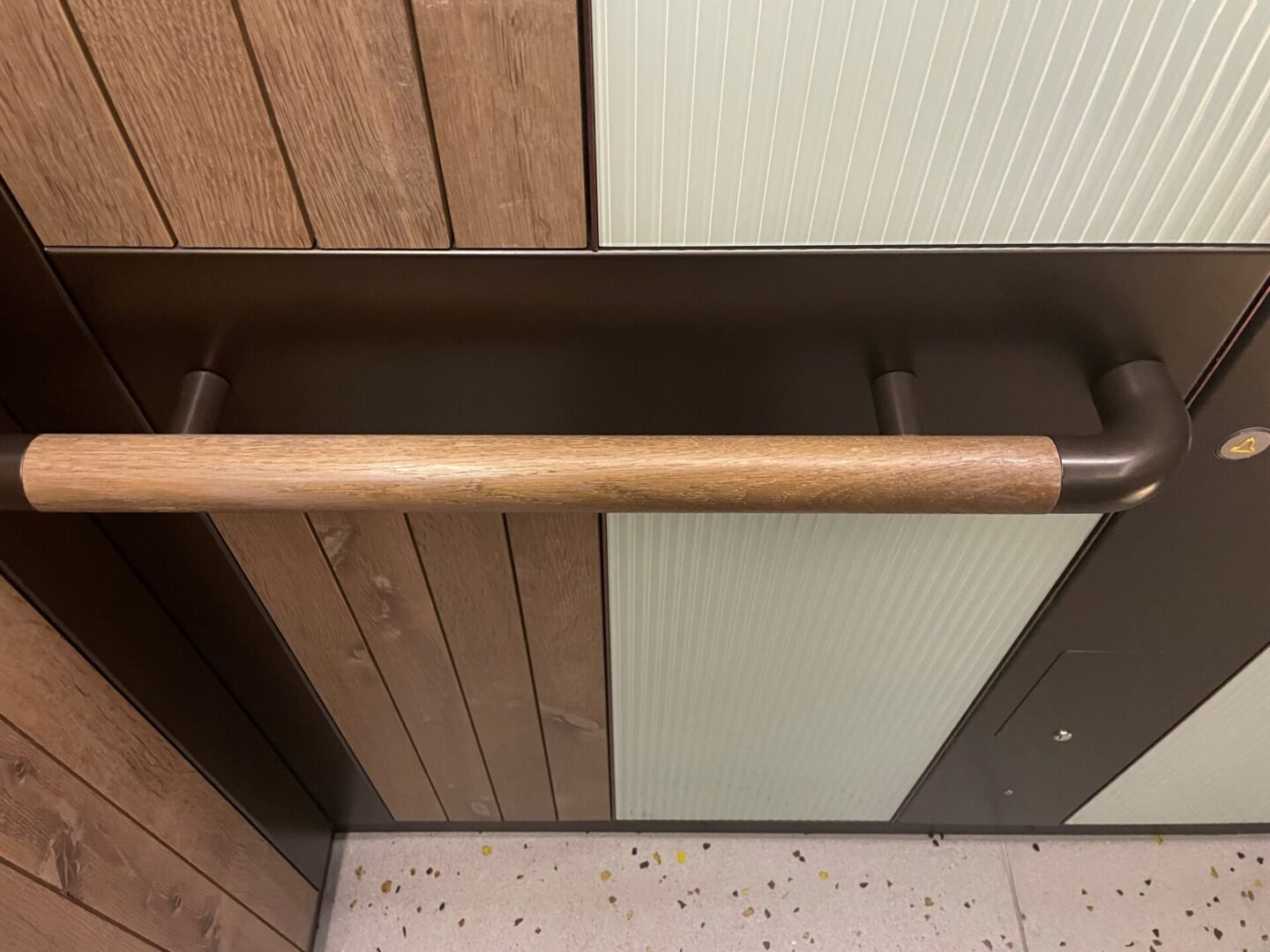 A wooden bat hanging from the ceiling of a room.