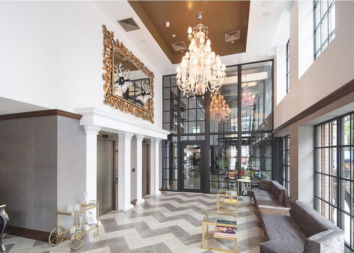 A large lobby with a chandelier and a mirror.