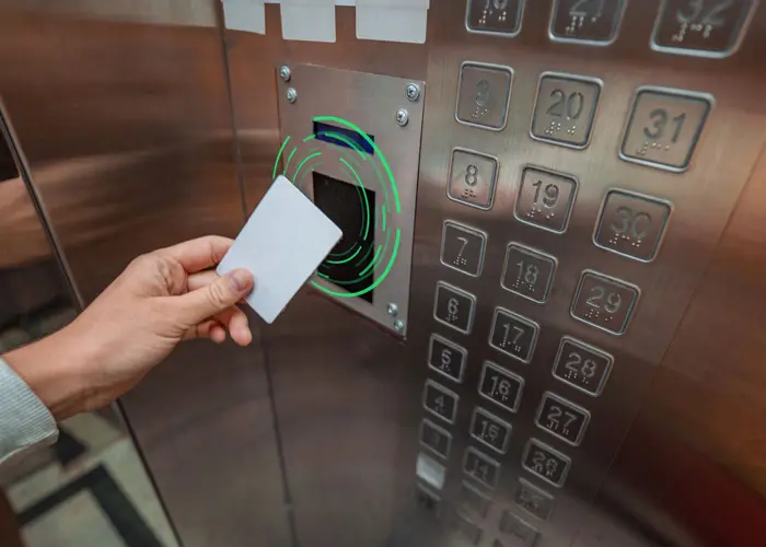 A person is holding onto the card in an elevator.