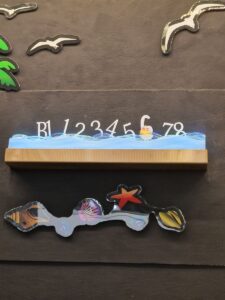 A wooden board with numbers and pictures on it
