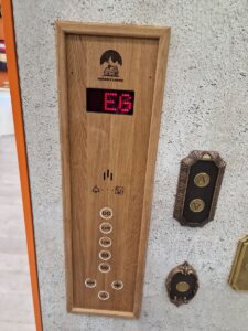 A wooden panel with the number e 6 on it.