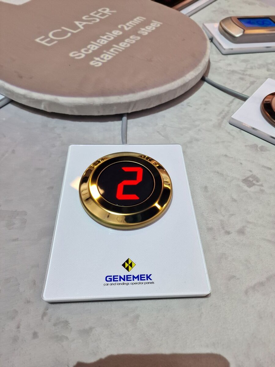 A gold and red button on top of a table.